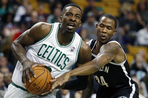 Boston Celtics' Jeff Green, left, drives for the basket past Brooklyn Nets' Chris Johnson (24) in the first quarter of a preseason NBA basketball game in Boston, Wednesday, Oct. 23, 2013. (AP Photo/Michael Dwyer)