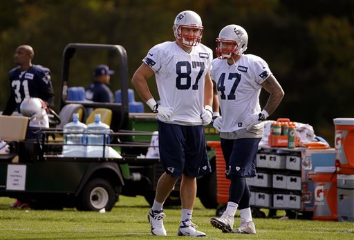 New England Patriots tight ends Rob Gronkowski (87) and Michael Hoomanawanui (47) walk between drills during a stretching and drills session before NFL football practice begins at the team's facility in Foxborough, Mass., Wednesday. The Patriots host the New Orleans Saints on Sunday.