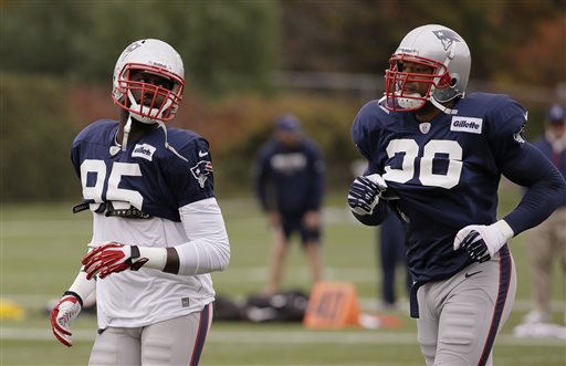 New England Patriots defensive end Chandler Jones (95) and newly reacquired defensive end Andre Carter (96), right, run during a stretching and drills session before practice begins at the NFL football team's facility in Foxborough, Mass., Wednesday, Oct. 23, 2013. The Patriots will play the Miami Dolphins Sunday. (AP Photo/Stephan Savoia)