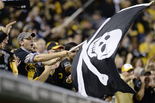A Pittsburgh Pirates fan waves a Jolly Roger flag as the Pirates play the Cincinnati Reds in the NL wild-card playoff baseball game Tuesday, Oct. 1, 2013, in Pittsburgh. (AP Photo/Don Wright)