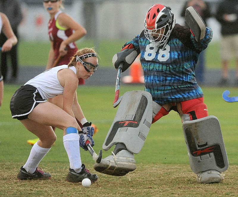 Skowhegan's Renee Wright, left, battles with Bangor High School goalie Rachel Luc, during a game at Tuesday in Skowhegan. The Indians defeated the Rams 10-0.