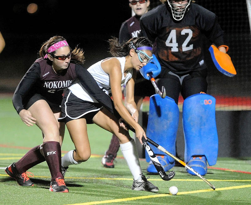 Skowhegan's Rylie Blanchet, right, tries to deflect a pass on goal as Nokomis' Kamryn Foss tries to defend in the first half Thursday of the Kennebec Valley Athletic Conference field hockey championship at Thomas College in Waterville.