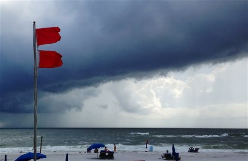 Red flags warn swimmers to stay out of the Gulf of Mexico as a squall from Tropical Storm Karen moves offshore at Gulf Shores, Ala., today. The beaches remained open, but authorities said dangerous underwater rip currents made the waters too dangerous to enter.