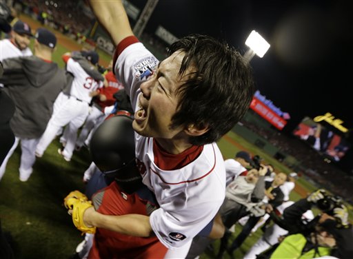 Boston Red Sox designated hitter David Ortiz carries relief pitcher Koji Uehara after winning Game 6 of baseball's World Series against the St. Louis Cardinals Wednesday, Oct. 30, 2013, in Boston. The Red Sox won 6-1 to win the series. (AP Photo/David J. Phillip) MLB
