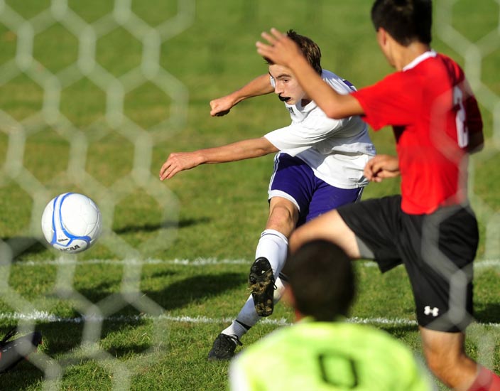 TAKE THE SHOT: Waterville Senior High School’s Michael Oliveira takes a shot on goal against Camden Hills Regional High School in the first half of their game Friday in Waterville.