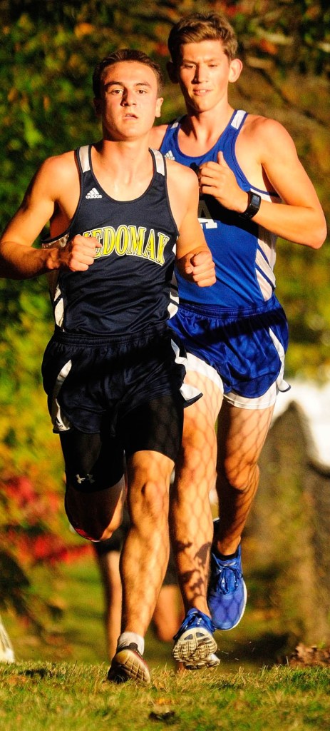Medomak’s Gavin Felch, left, passes Erskine Academy’s Gavin Felch during a cross country meet on Wednesday at Erskine Academy in China. They stayed in that order to finish first and second.