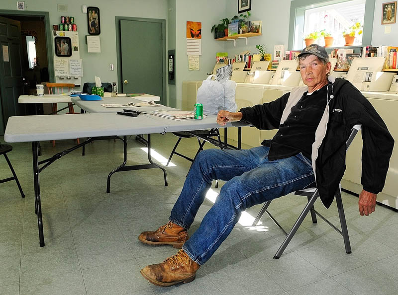 Roland Rideout sits in Mary's Place Laundry on Thursday in Augusta. The laundromat near the corner of Washington and Jefferson Streets is close to the apartment building where he lived that was closed by the city for safety code violations.