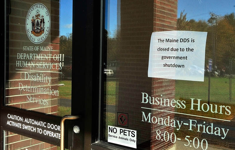 This sign in the window announces that Department of Health and Human Services Disability Determination Services office is closed due to federal government shutdown on Tuesday October 8, 2013 in Winthrop.