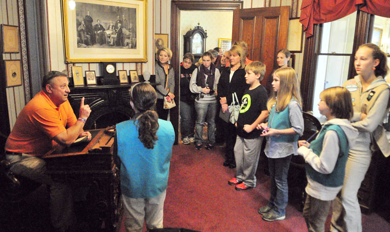 Gov. Paul LePage talks sits at James Blaine's senatorial desk in the Blaine Study while leading a tour for people who donated to a food drive on Saturday at the Blaine House in Augusta. He told the visitors about Blaine who lived in the house, that is now Governor's mansion at the corner of State and Capital Streets. Besides being a Senator, Blaine was Speaker of the House, an 1884 Republican presidential candidate, US Secretary of State and part-owner of the Kennebec Journal.