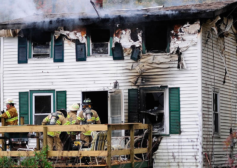 Firefighters work at 119 Granite Hill Road today in Manchester. An early morning fire there claimed Sam Spinicci, 56, owner of Kennebec Taxi and a Navy veteran, his family said.