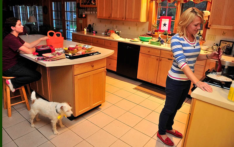 Kimberlee Lewis, left, chats with her mother, Lynn Lewis, while she makes dinner on Wednesday at their home in Monmouth.