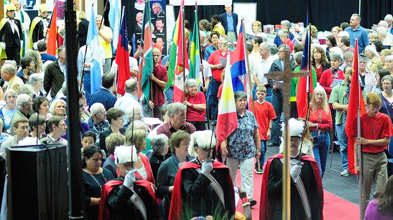 Flagbearers march during the entrance procession for the opening mass of "The Great Commission: One Family in Mission" event today at the Augusta Civic Center. The featured speaker was scheduled to be Mario St. Francis, a motivational speaker and lay Catholic evangelist.