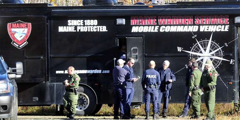 Officers from various agencies confer outside the Maine Warden Service Mobile Command Vehicle parked on Nike Lane in Oakland as officers searched the woods for signs of missing toddler Ayla Reynolds on Wednesday.