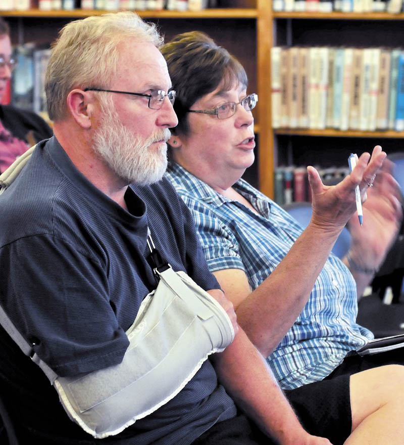 Brenda Lint asks questions during a presentation on the Affordable Care Act today at the Waterville Public Library. Her husband, Mark, is seated to her right.