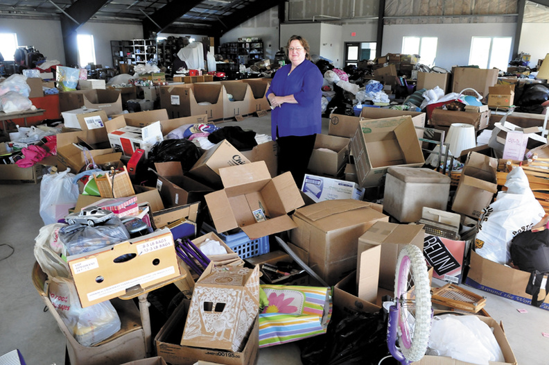 Mid-Maine Homeless Shelter Executive Director Betty Palmer stands in the second floor of the Waterville facility that is filled with items used by clients at the shelter. Plans are being considered to renovate the space for employment training and a daycare.