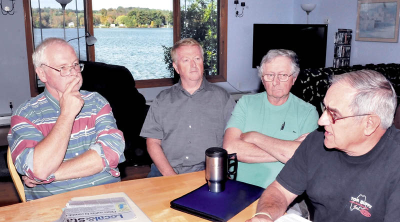 With China Lake seen in the background, these China residents expressed concern over the costs to the public if the former Cabins lakefront property is developed into the China Community Park. Pictured are, from left, Scott Adams, Scott Croker, Herb Tyler and Sheldon Bumps.