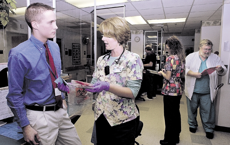 Brandon Giberson, then 17, speaks with registered nurse Bobbi McCarthy in 2005 about blood in the emergency room nurses' station, at Redington-Fairview General Hospital in Skowhegan, where he volunteered. Giberson was then an Upper Kennebec Valley Memorial High School senior.