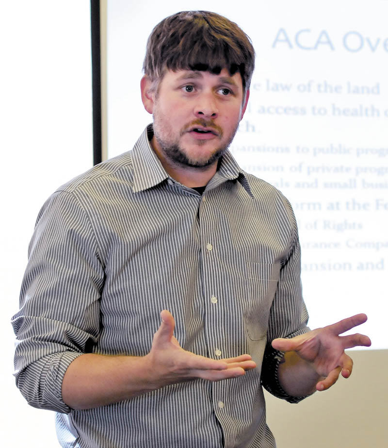 Jake Grindle, of the Western Maine Community Action Program, explains the Affordable Care Act to a group at the Waterville Public Library today.