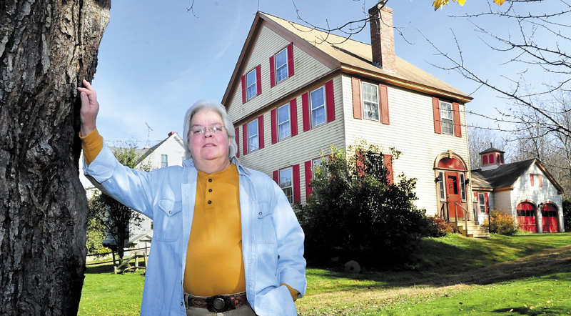 SPIRITS: Marty Golias stands outside her home on the Falls Road in Benton. Golias, originally from Salem, Mass., has lived at the home for 13-years and believes the home has friendly spirits inside.