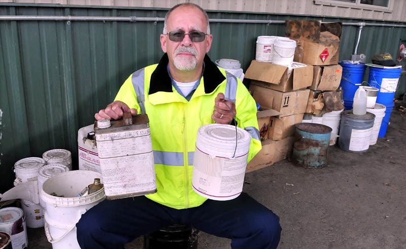 Winslow Public Works Director Paul Fongemie holds unwanted containers of liquids that are among some of the items that can be dropped off for disposal at the town garage on Halifax Street this Saturday.