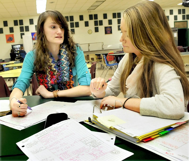 MENTOR: Rebecca Ellis, left, tutors Carrabec High School student Taylor Bartlett recently at the North Anson school. Ellis is an AmeriCorps volunteer and one of five volunteers to participate in the program thanks to a $726,800 federal grant to hire up to 35 volunteers.