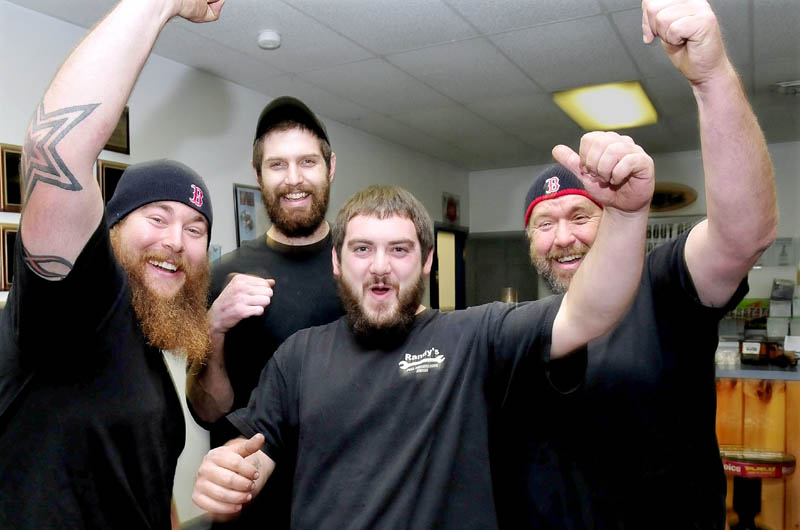 Red Sox baseball team fans whoop it up while talking about the prospects of the team winning the World Series that begins Wednesday while at Randy's Auto Repair in Skowhegan on Tuesday. From left are Mike Bruce, Dylan Adam, Quentin Frigon and Randy Bruce.