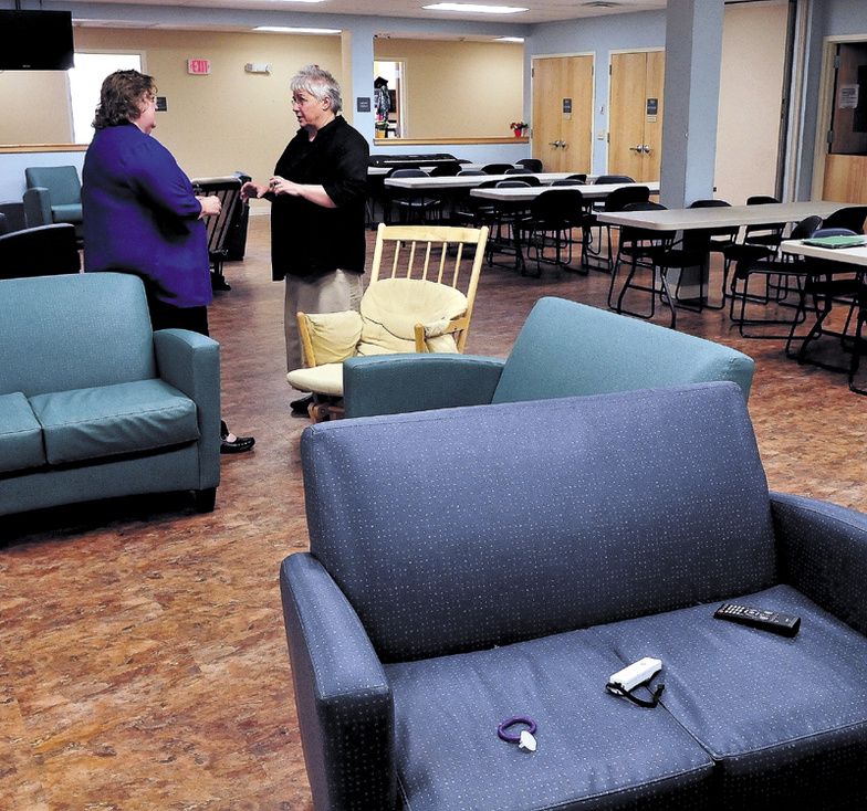 Mid-Maine Homeless Shelter Executive Director Betty Palmer, left, and Shelter Volunteer Coordinator Sheila Bacon confer in the multi-purpose room at the Waterville facility on Tuesday.