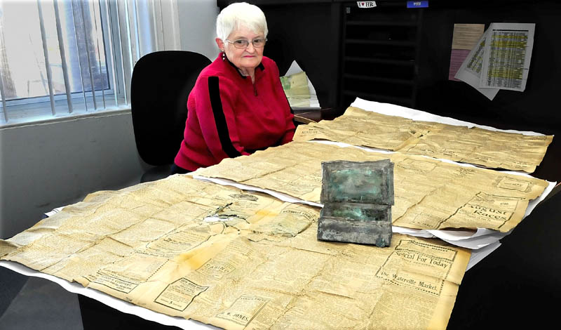 Trudy Lovely, superintendent of the Pine Grove cemetary in Waterville, displays a small box that contained a penny, pen and four 1907 Morning Sentinel newspaper pages that was found by workers tucked away in a time capsule near a corner stone at the cemetary chapel.