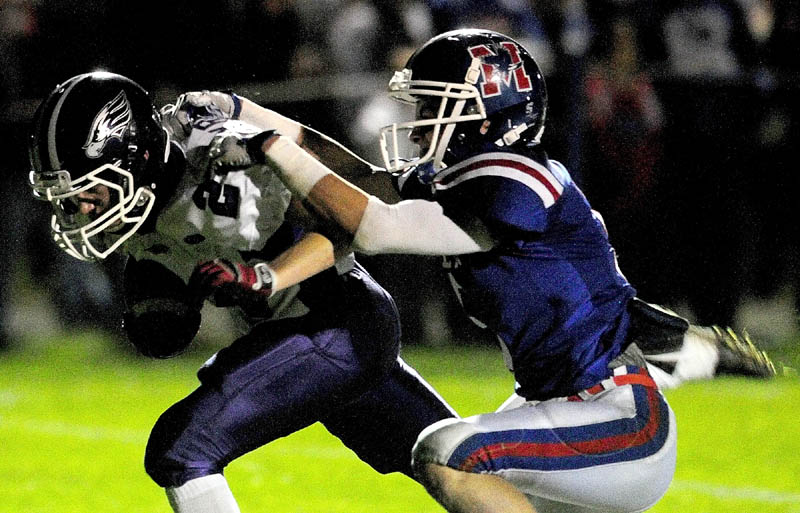 STOP RIGHT THERE: Marshwood’s Noah Kreider, left, is tackled by Messalonskee’s Devin Warren during their game Friday in Oakland Marshwood beat Messalonskee 40-19.