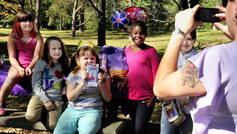 The beautiful summer-like day on Sunday brought these kids outdoors to celebrate the birthday of Cynthia Morin, 7, holding a present, as Anna Morin, at right, photographs the kids at Coburn Park in Skowhegan. From left are Hannah Huntley, Mikayla Chase, Cynthia, Beyonce Ward and Emma Huntley.