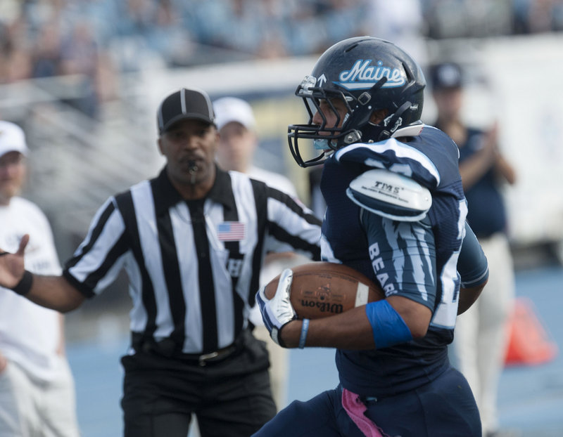 Nigel Jones crosses the line for one of his two running touchdown’s in Maine’s 62-28 victory. He added another on a pass and piled up 107 yards rushing.