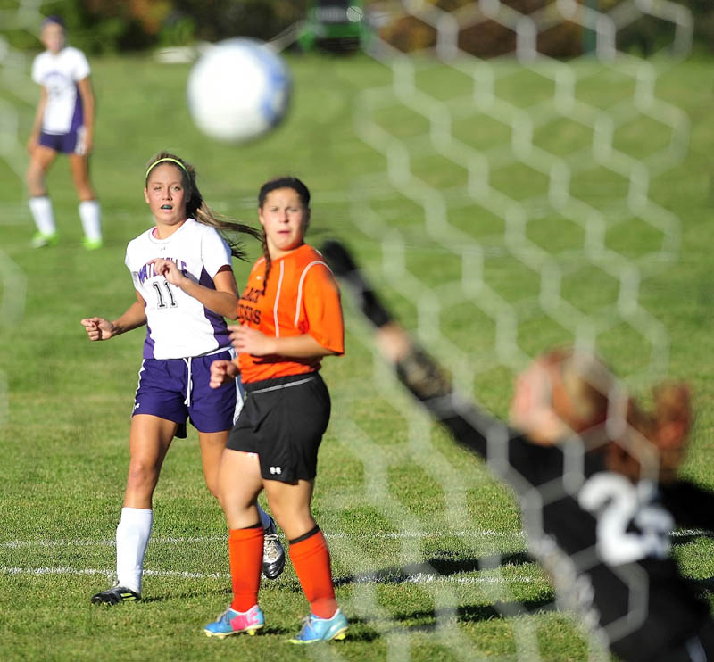 Waterville Senior High School's Colleen O'Donnell, 11, back, watches as her shot on goal gets past Winslow High School goalie Hillary Libby, 25, in the first half in Waterville on Tuesday. Waterville defeated Winslow 3-0.