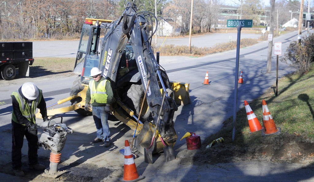 PATCHING: Tetra Tech employees Chad Kemp, left, and Tyler Frost patch Arsenal Street in Augusta on Wednesday after crews repaired a Summit Natural Gas pipeline that leaked air the night before.