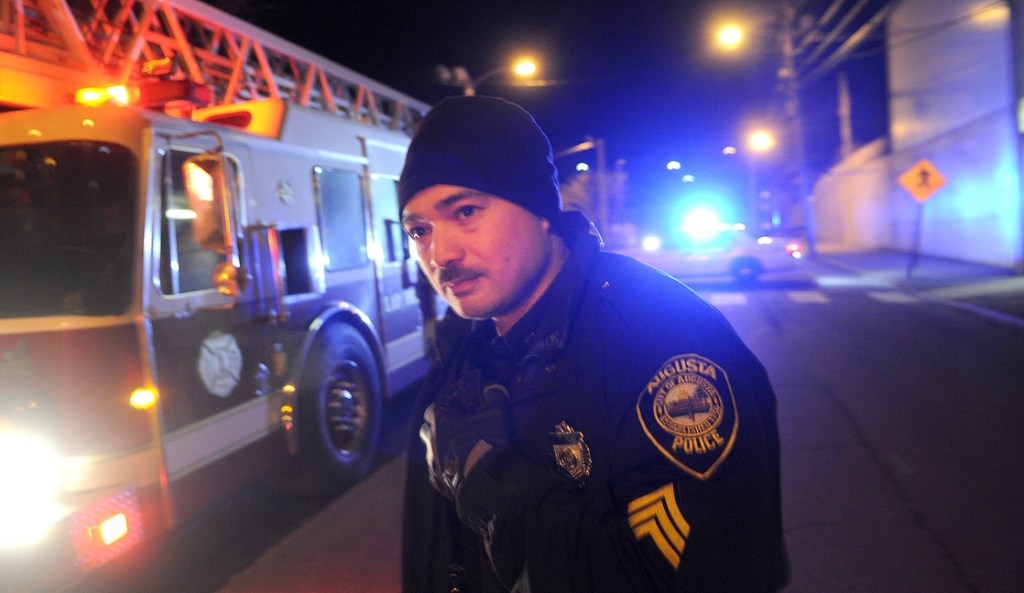 FAILED TEST: Augusta Police Dept. Sgt. Vincente Morris looks down Arsenal Street after the street buckled Tuesday night above a natural gas pipeline, resulting in evacuations of nearby residents. Authorities determined that air in a Summit Natural Gas pipeline erupted during a pressure test.