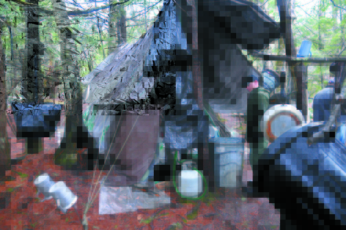 Camp: District Game Warden Aaron Cross inspects Christopher Knight’s camp in a remote, wooded section of Rome.
