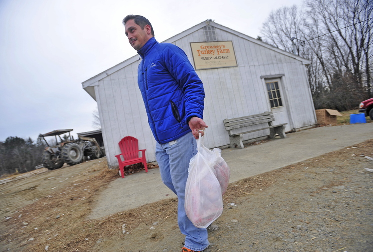 bird pickup: Chris Flye of Waterville leaves Greaney’s Turkey Farm with two fresh turkeys for Thanksgiving dinner on Tuesday. Frye has never tried a free-range, grain fed turkey before.