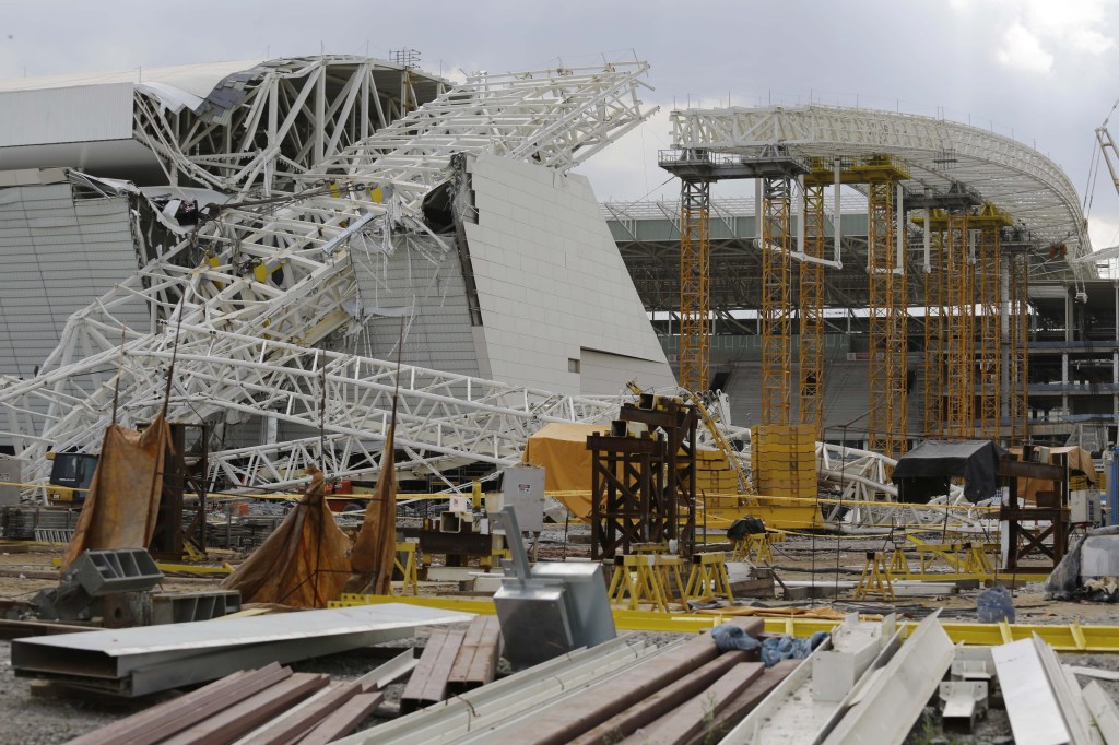 A metal structure that buckled sits on part of the Itaquerao Stadium in Sao Paulo, Brazil, on Wednesday. Part of the stadium that will host the 2014 World Cup opener in Brazil collapsed, causing significant damage and killing at least two people, authorities said.