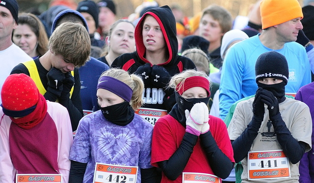 CHILLY: Runners area bundled up against the cold at the start of the Gasping Gobbler 5k run which beganand finished at Cony High on Thursday November 28, 2013 in Augusta. There were over 400 registrants in the event that gave turkeys and other Thanksgiving dinner groceries as prizes.
