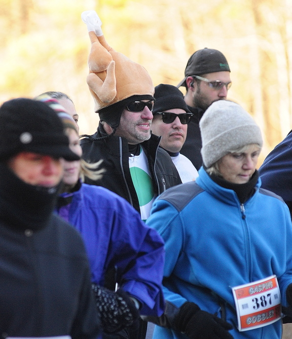 IT’S COLD: Runners area bundled up against the cold at the start of the Gasping Gobbler 5k run which began and finished at Cony High on Thursday November 28, 2013 in Augusta. There were over 400 registrants in the event that gave turkeys and other Thanksgiving dinner groceries as prizes.