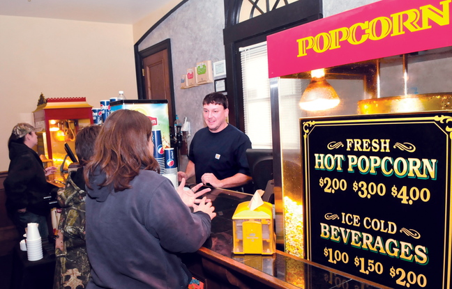 NEXT: Matt Dexter works filling orders in the concession room at the Strand Theater in Skowhegan that he and his wife Misty purchased in September.