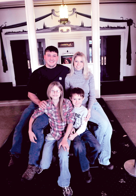 FAMILY AFFAIR: Matt and Misty Dexter with their children Bailey and Max in the lobby of the historic Strand Theater in Skowhegan that the couple purchased last September.