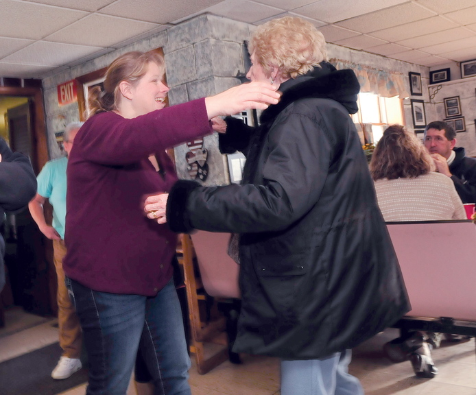GRATEFUL: Louise Bougie, right, hugs What’s For Supper restaurant owner Laura Lorette after a Thanksgiving Day meal at the Norridgewock restaurant today.