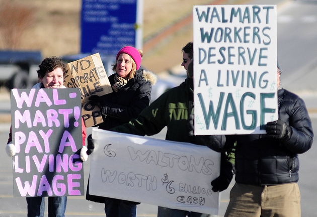 PROTESTERS: Protesters hold signs on Xavier Loop during a Black Friday protest at the Walmart Supercenter in Augusta.