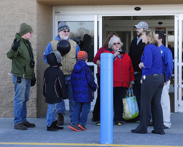 PROTEST: Priscilla Jenkins, of Moveon.org, in red, fourth from right, reads aloud a statement to several Walmart employees, right, during a Black Friday protest outside the Walmart Supercenter in Augusta. Jenkins, also a Winthrop town councilor, swore at the employees as they were asking her group to leave the premises.