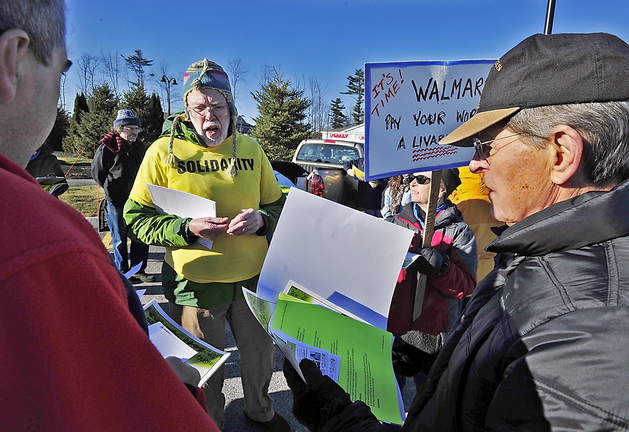 John Newton, right, a member of the executive board of the Maine AFL-CIO, hands out literature Friday to protesters and encourages them to enter the Walmart in Scarborough and talk to employees and customers. Demonstrations were held at about 1,500 Walmarts across the country.