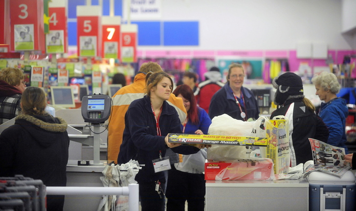 BLACK FRIDAY: Abi Hewins, a cashier at Kmart, checks out customers on Black Friday at Kmart on upper Main Street in Waterville.