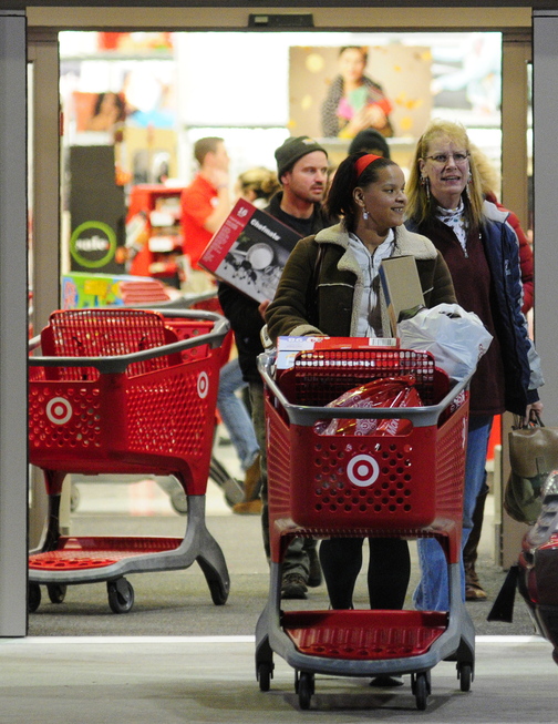 Black FRIDAY: Shoppers roll carts out the Target store during early morning Black Friday shopping at 5:07 a.m. Friday in Augusta.