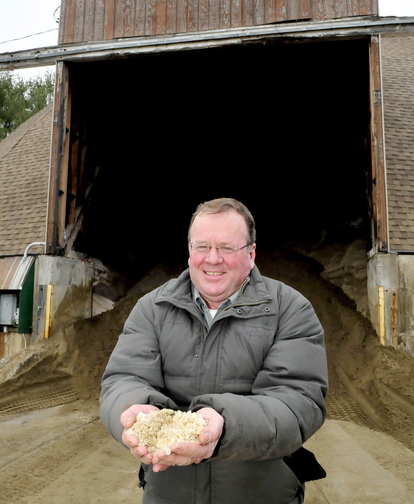 Staff photo by David Leaming PASS THE SALT: Skowhegan Road Commissioner Greg Dore holds a handful of some of the salt that is mixed with sand at the town sand shed. Dore said without the use of salt the roads would be more dangerous for drivers and expensive for the town to maintain roadways.