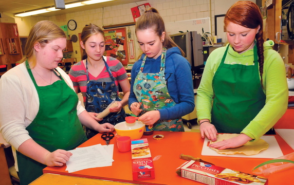 FOOD FOR THOUGHT: Skowhegan Area High School students in the Basic Foods class prepare to make meals recently. From left are Emily Greaney, Mariah Bonneau, Laura Wolters and Monique Thompson.