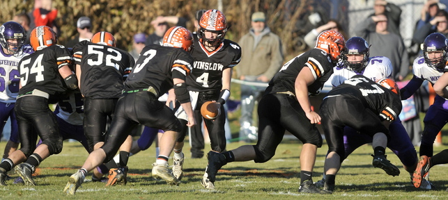 CLEARING THE WAY: Winslow running back Dylan Hapworth (3) prepares to take the handoff from quarterback Bobby Chenard during the Eastern C regional championship. Offensive linemen Alex Clark (54), Bryce Gilliland (52) and Dustin Fitch (67) are part of a group that has helped the Black Raiders average 40 points per game.